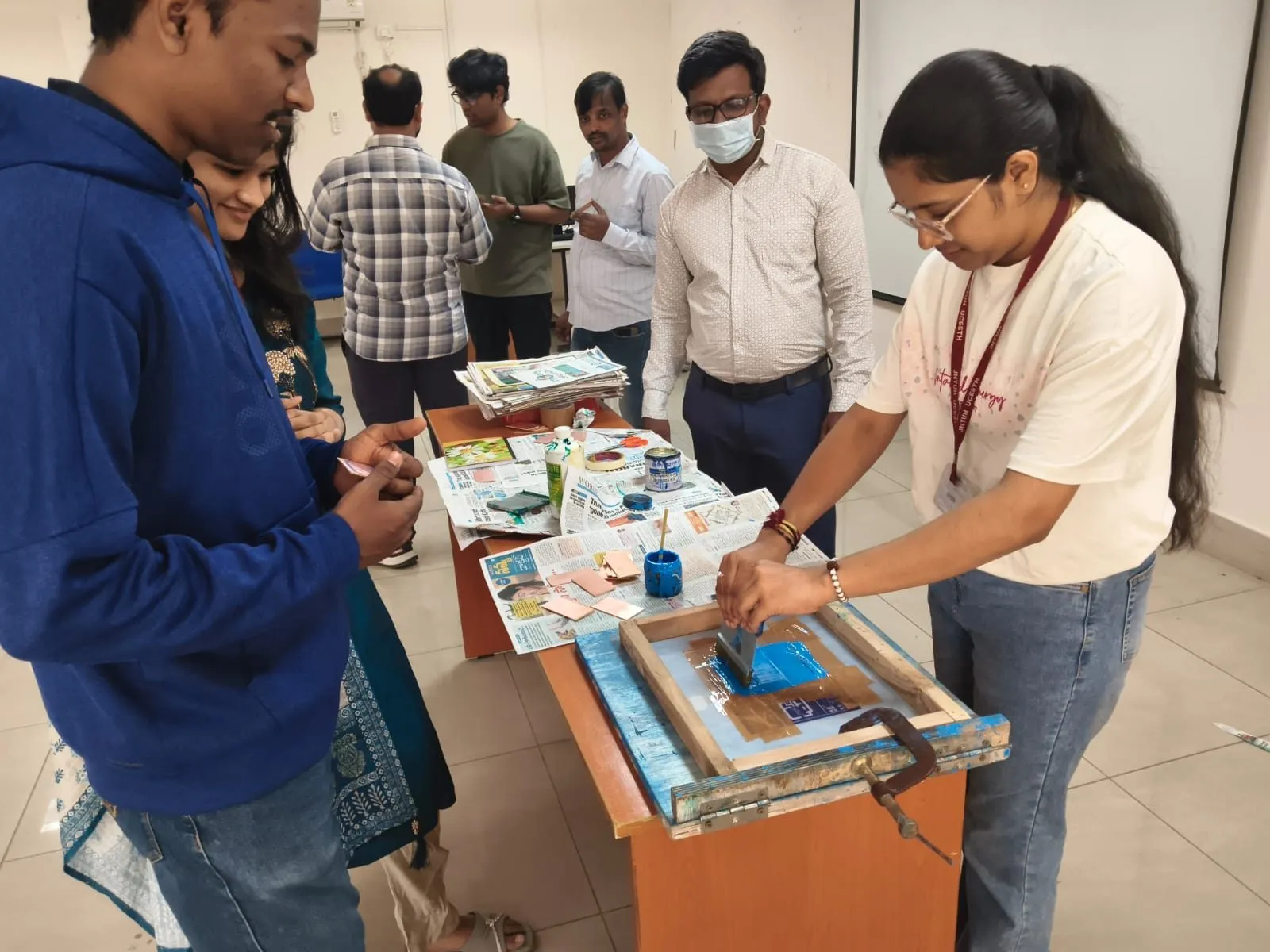 Participants preparing PCBs using screen printing during the workshop