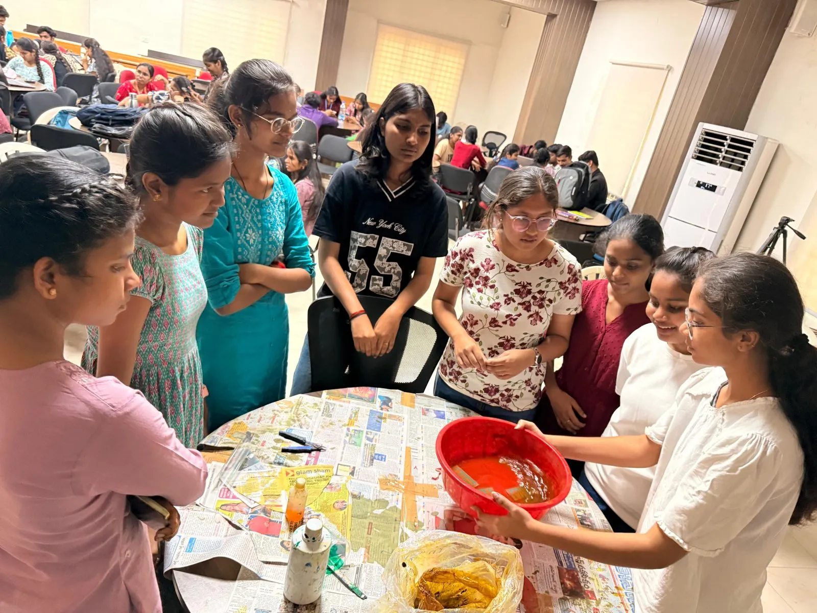 Students gathered around a table with trays during PCB making