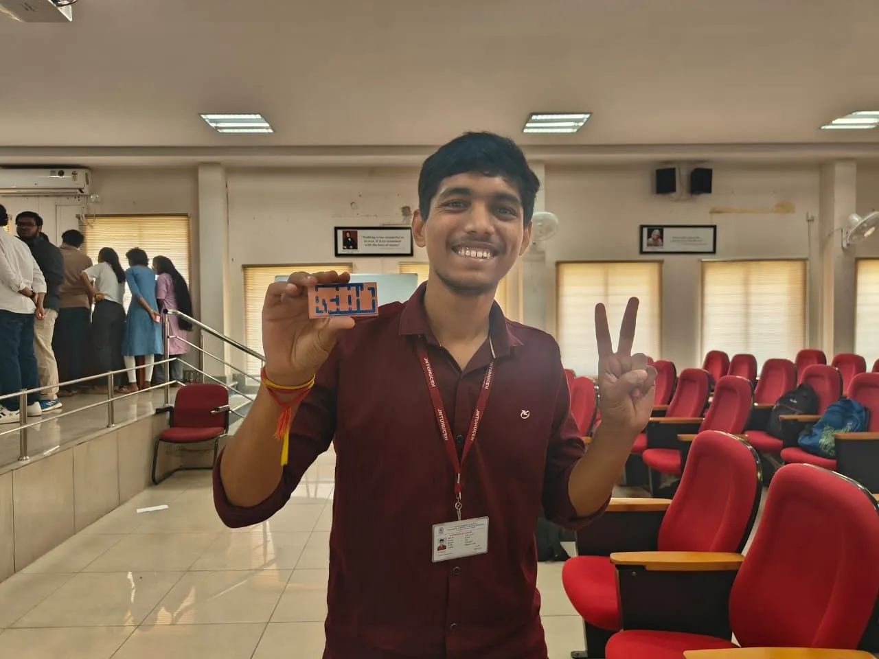 A student holding up the PCB he made