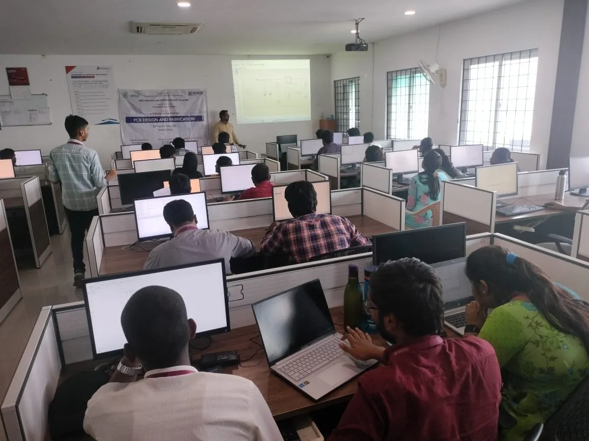 Students designing a PCB on computers in a lab