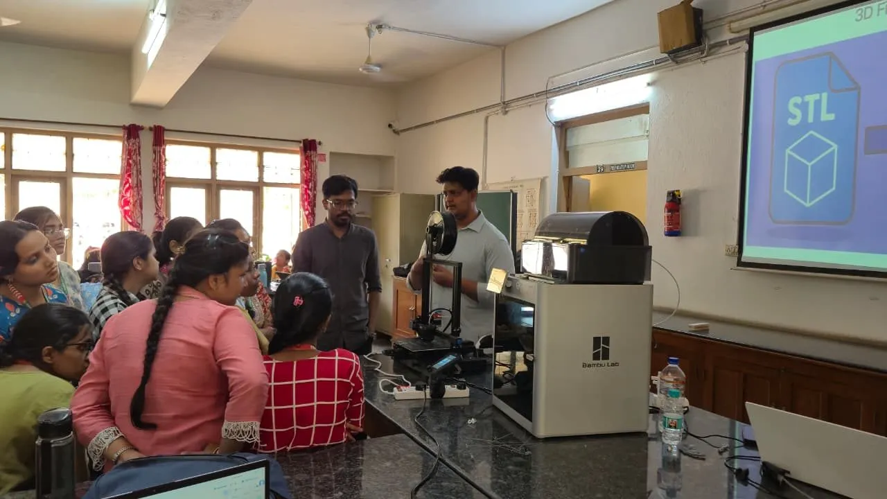Participants gathered around a 3D printer during a live demonstration
