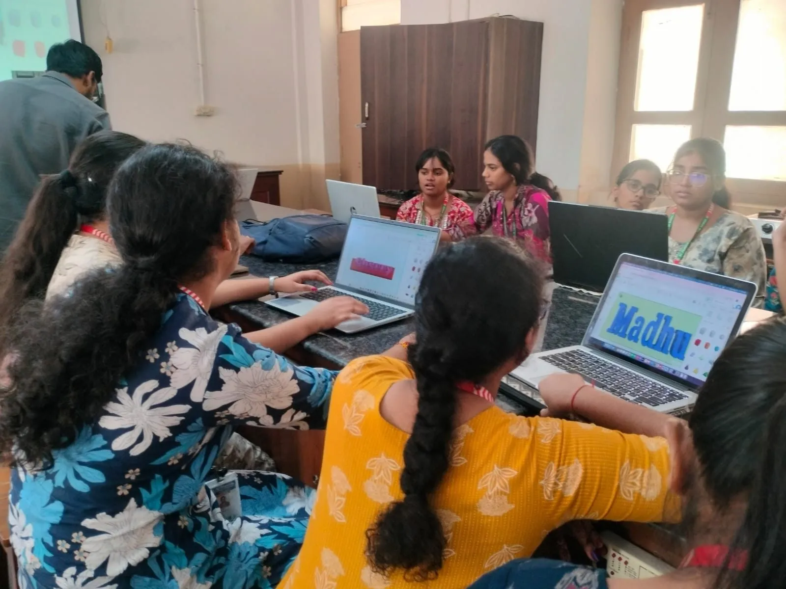Participants designing 3D models on their laptops