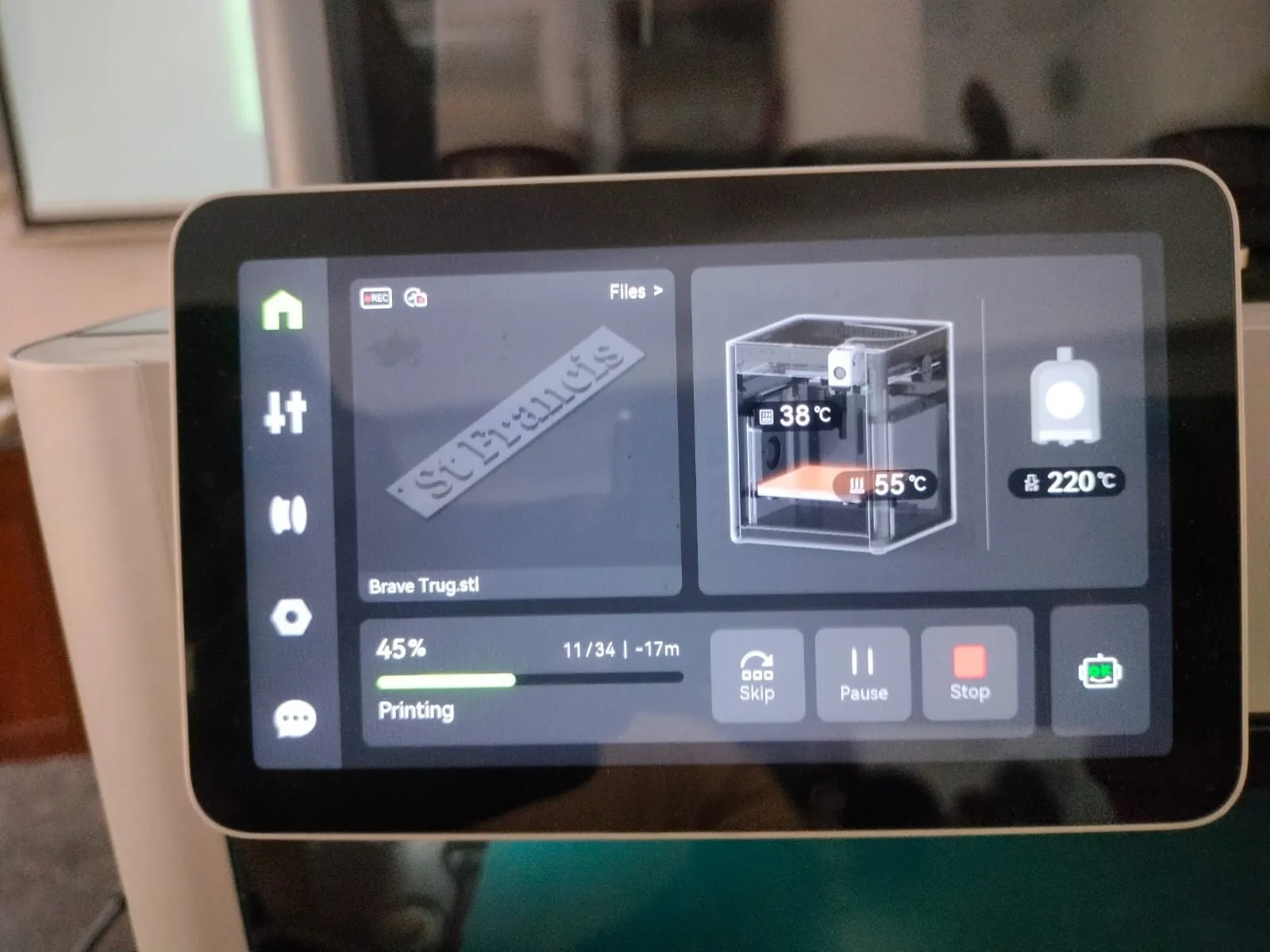 The touchscreen of a 3D printer showing a print in progress