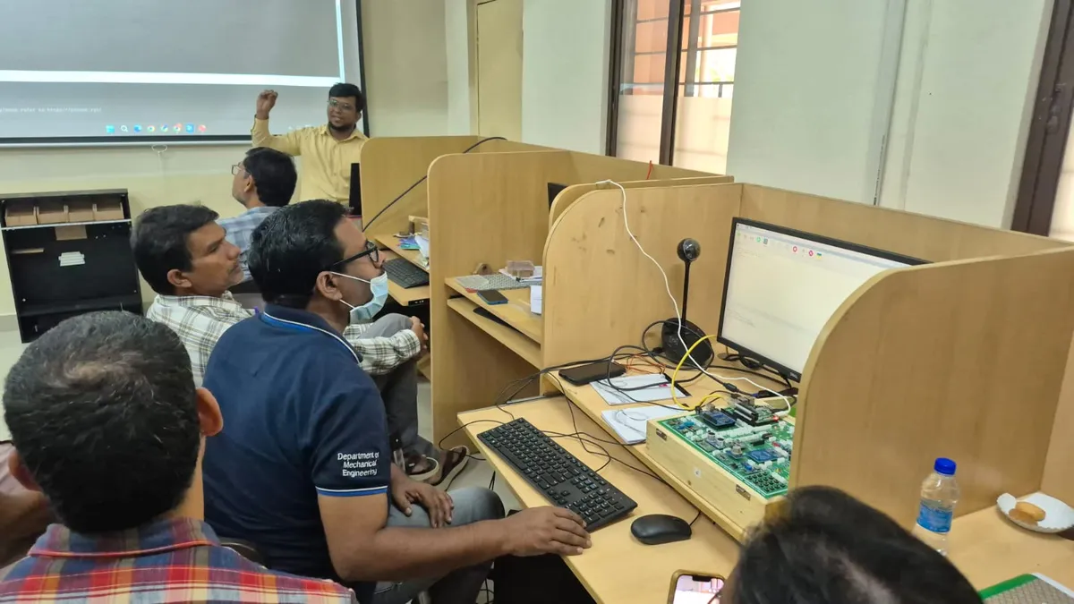 Faculty participants working on development boards at lab computers