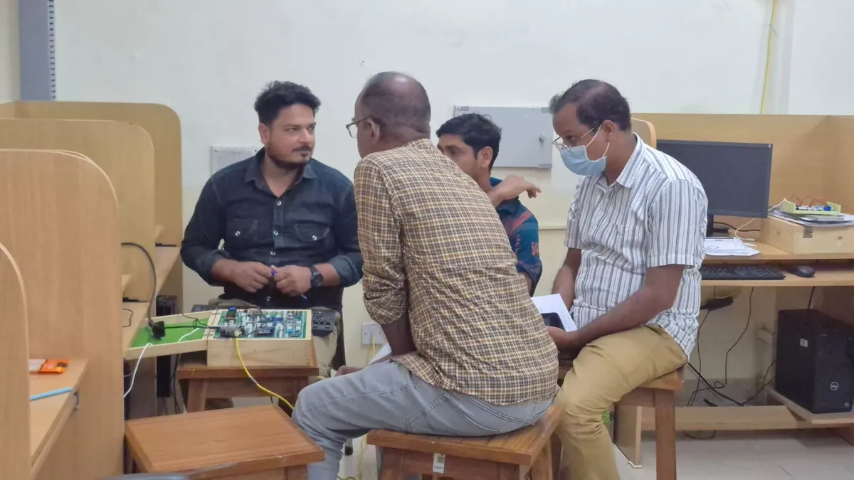 Two faculty members discussing a hardware exercise during the program