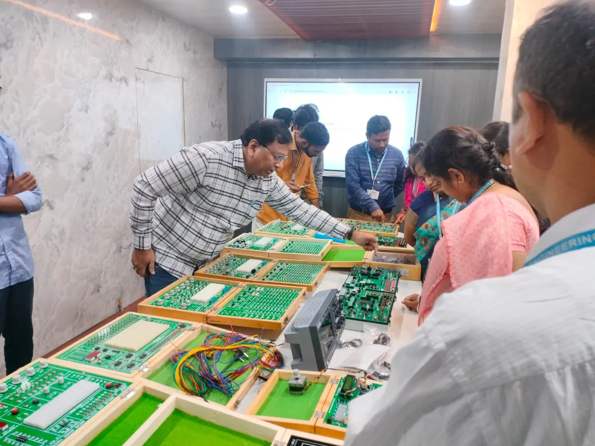 A trainer guiding faculty through a hands-on exercise at the trainer kits